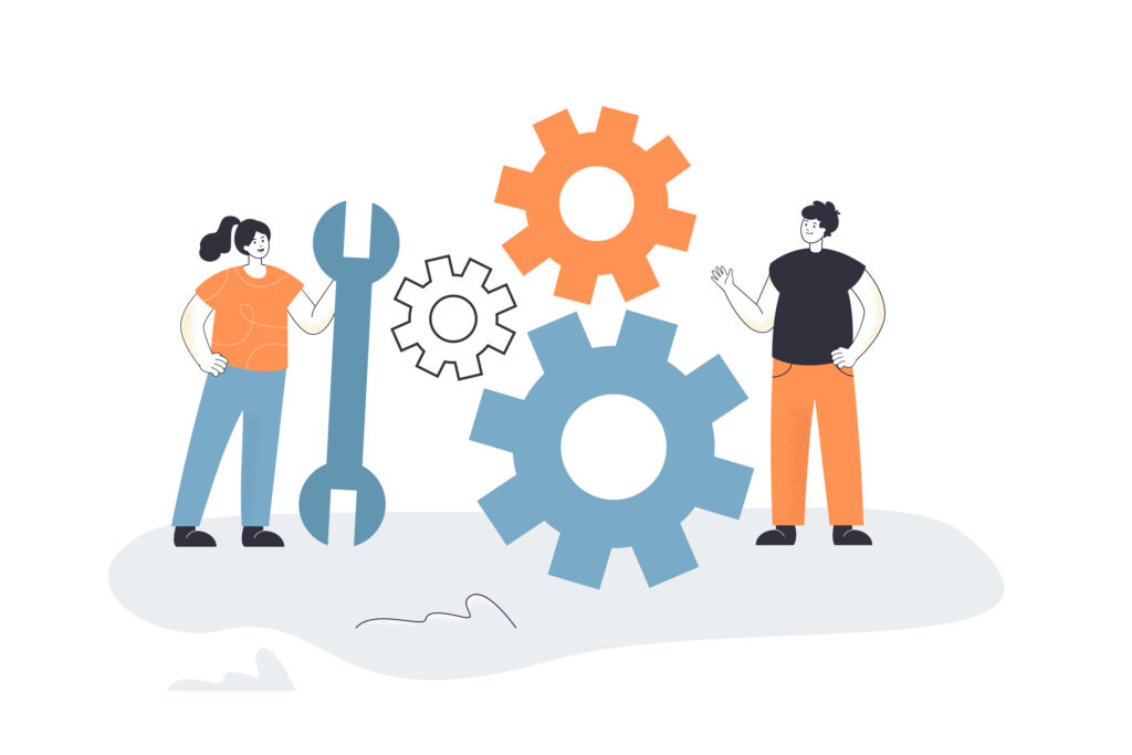 Ein Mann und eine Frau haben zwischen sich einen Schraubenschlüssel und Zahnräder für einen Umbau.